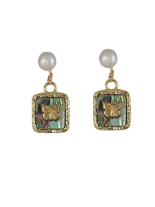 Detail of vintage gold earrings with white pearls and butterfly on shell inlay