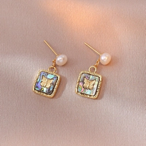 Elegant gold butterfly earrings with pearl accent and colorful abalone shell inlay