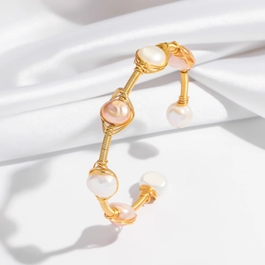 Elegant gold open bangle with white and pink pearls featuring handmade wire wrapping craft