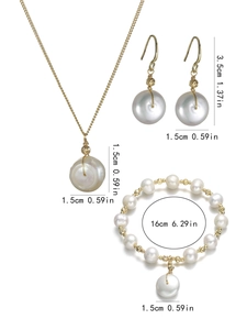 Detailed view of baroque pearl jewelry set with gold necklace, earrings and bracelet