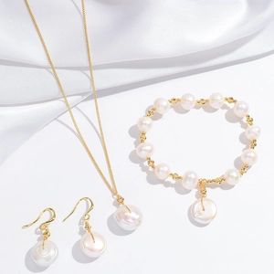 Elegant baroque pearl jewelry set with necklace bracelet and drop earrings on white silk