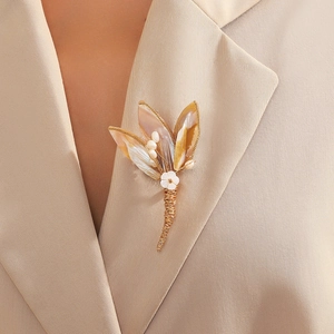 Exquisite shell flower brooch with pearls on beige blazer for a vintage aesthetic look