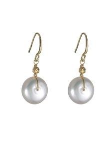 Detail of baroque freshwater pearl earrings with gold-plated hooks and wire wrapping