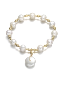 Detail of freshwater pearl bracelet with spiral engraved gold beads and central pearl drop