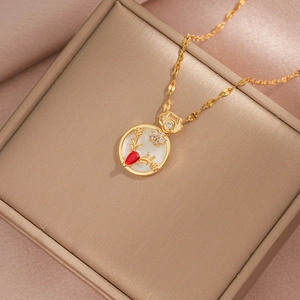 Elegant gold titanium necklace with red teardrop gem and deer flower pendant on silk