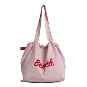 Pink canvas tote bag with red Beach embroidery and long shoulder straps for daily use