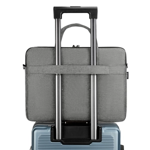 Gray Oxford laptop bag with back luggage strap mounted on a suitcase handle