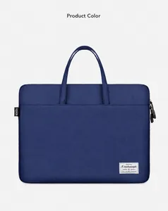Detail view of a navy blue canvas laptop bag showing zipper closure and front pocket
