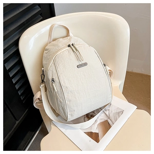 Detail of off-white nylon backpack with crinkled texture and dual zipper closure