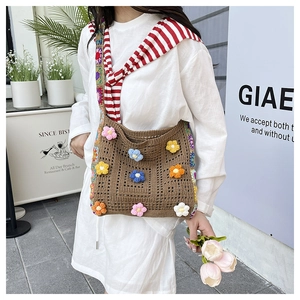Detail of dark brown crochet tote with 3D floral accents and rainbow shoulder strap