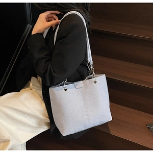 Detail of light blue tote bag showing twill fabric texture and silver metal rings