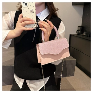 Detail of pink glitter flap handbag with silver chain strap and smooth leather finish
