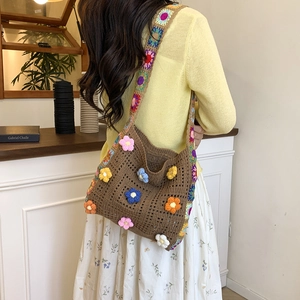 Handmade crochet beach bag with 3D floral accents and bohemian woven shoulder straps