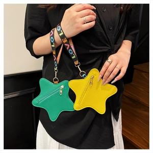 Detailed view of star-shaped coin purses in green and yellow with LOVE woven wristlets
