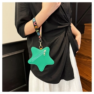 Macro view of green star-shaped leather coin purse with colorful LOVE woven strap