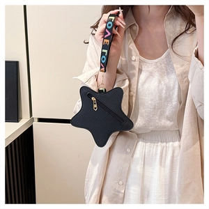 Detail of black star coin purse with litchi grain leather and LOVE ribbon strap