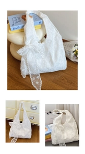 Close-up of white floral lace embroidery and ribbon bow on large shoulder tote bag