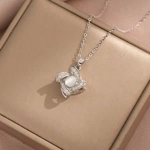Elegant rotating flower clover necklace with cat eye stone and cubic zirconia in a gift box
