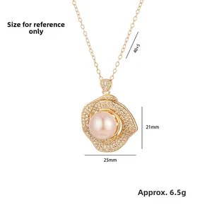 Detail view of gold flower pendant with zircons and pearl including dimension markers