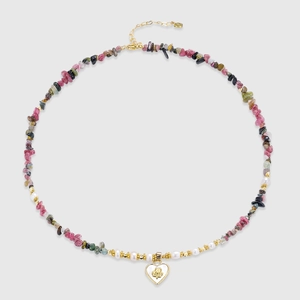 Detail of beaded necklace with freshwater pearls, colorful stones and heart pendant