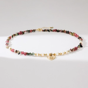 Detail of baroque pearl necklace with colorful tourmaline beads and heart flower pendant