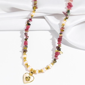 Detail of colorful tourmaline stones and freshwater pearls with gold heart pendant