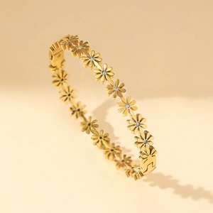 Elegant gold-plated daisy flower bangle with crystal centers and snap closure buckle