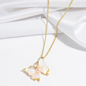 Detail of butterfly necklace with shell wings, pink pearl, and fine gold chain