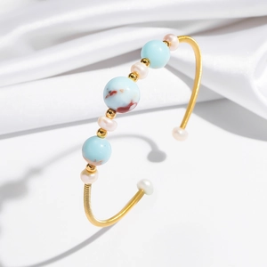 Minimalist gold open bracelet featuring natural pearls and blue marble textured stones