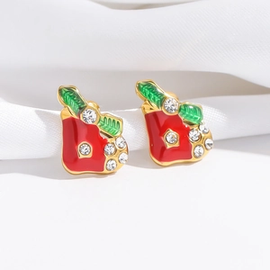 Christmas apple stud earrings with red enamel and crystals on white silk background