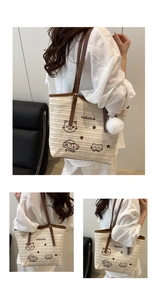 Détail du sac cabas en paille avec broderie chat, anses en cuir et pompon en peluche