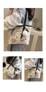 Détail du grand sac cabas tressé crème avec broderie chat et bandoulière noire