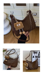 Detail view of brown textured half-moon tote bag with cute plush toast charm accessory