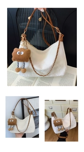 Detail of white textured hobo bag with brown leather strap and plush cartoon pendant
