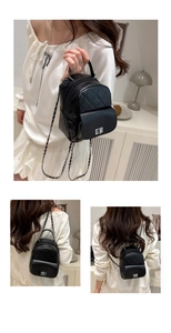 Detail eines schwarzen Mini-Rucksacks mit Steppmuster, Metallkette und Drehverschluss