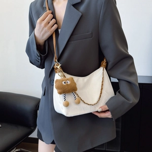 Minimalist white PU leather pillow bag with brown plush charm and metal chain strap
