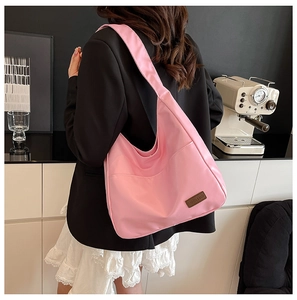 Detailed view of pink lightweight nylon Hobo shoulder bag with fashion leather patch