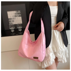 Close-up of pink faux leather hobo bag with vintage minimalist design for women