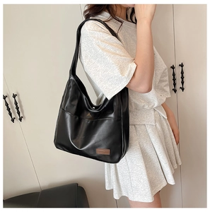 Detail shot of the black soft PU leather hobo bag featuring a vintage minimalist design