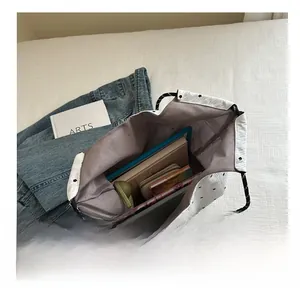 Internal view of polka dot tote bag showing spacious capacity for books and tablet