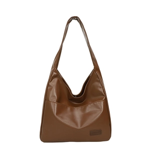 Minimalist large brown PU leather tote bag with a front pocket on white background