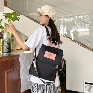 Contrast color nylon backpack for college students with pink tassels and striped straps