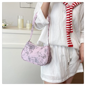 Lavender bamboo leaf print shoulder bag displayed on shoulder with white knitwear