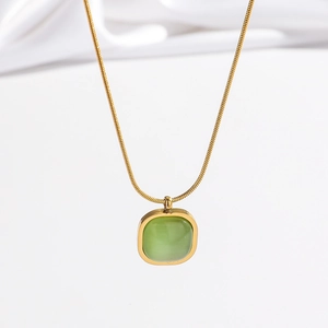 Elegant gold snake chain necklace with green cat-eye stone pendant on white background