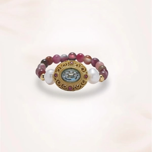 Detailed view of beaded flower ring with freshwater pearls and blue gemstone centerpiece