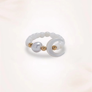 Detail of beaded ring featuring freshwater pearl, moon-shaped shell and golden metal beads