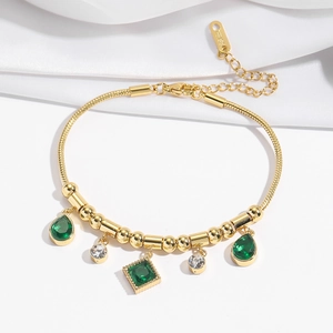 Elegant gold stainless steel bracelet featuring green emerald and white zircon pendants