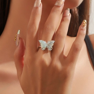 Elegant vintage butterfly open ring featuring pale green stone and zircon pavé detail