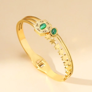 Gold stainless steel bangle with emerald cat-eye stone and hollow star patterns