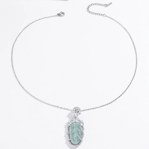 Elegant leaf pendant necklace with green stone and sparkling zircons on silver chain